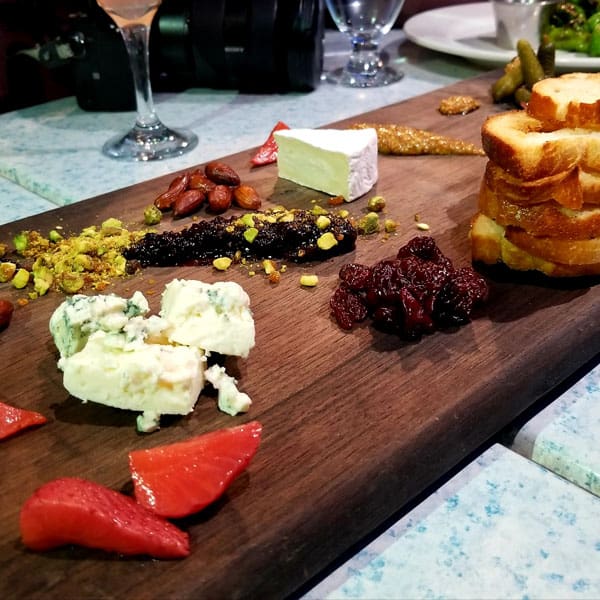 wooden snack platter from Belton chalet with cheese, bread, nuts, berries and jams