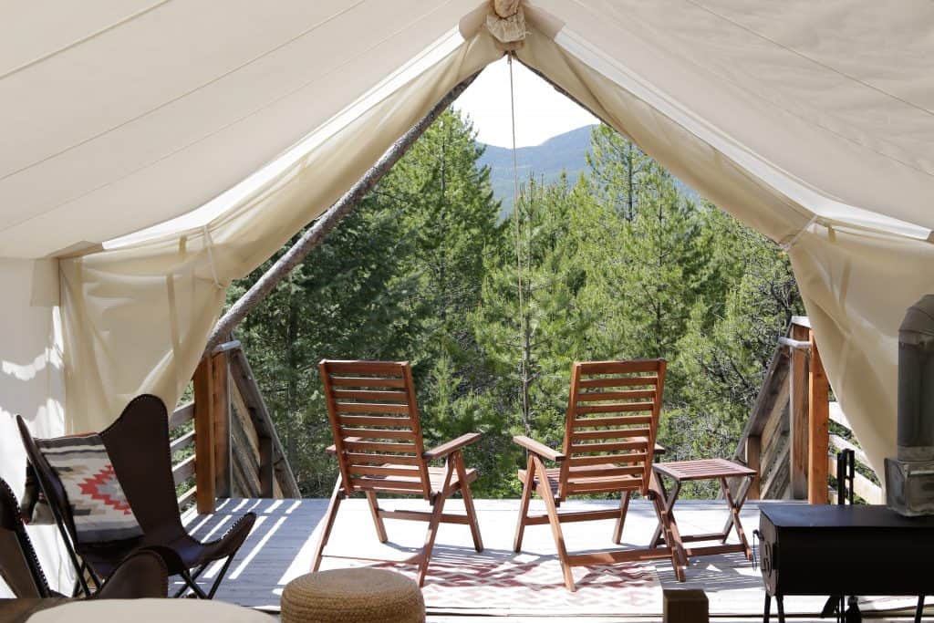 inside of tent at Under Canvas Glamping Glacier National Park with two chairs looking out the opening