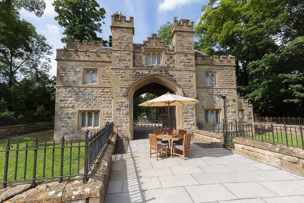 Castlegate glamping castle view from outside with table and trees