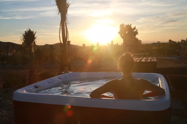 Joshua Tree Glamping Yurt at Joshua Tree Houses Hot tub view with sunset