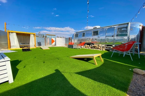 Airstream Oasis in Joshua Tree view inside of trailer with bed and kitchen painted blue