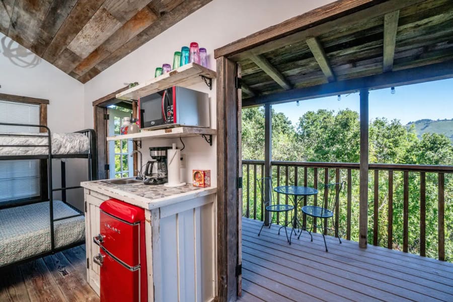 rustic glamping Tiny House view of inside and out onto the deck